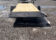 2026 Quality Steel & Aluminum 8320TILTEH14K Hydraulic Tilt Equipment Hauler on a gravel lot, showcasing its advanced tilting mechanism and robust construction.