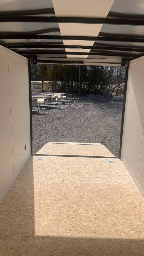 Sleek Discovery 7x16 Rover ET Enclosed Trailer with Blackout Package, showcased in an outdoor setting.