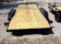2025 BNM 7x18 Car/Toy Hauler with rear beavertail, pullout ramps, and black wheels