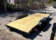 2025 BNM 7x18 Car/Toy Hauler with rear beavertail, pullout ramps, and black wheels
